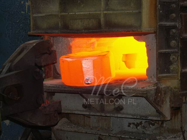 Heated material being removed from the furnace before forging
